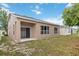 The backyard features a covered patio and space for outdoor activities or relaxation, a blank slate for future owners at 7551 Bear Claw Run, Orlando, FL 32825