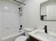 Well-lit bathroom with modern fixtures including a white tiled shower and dark hardware at 7551 Bear Claw Run, Orlando, FL 32825