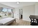 Bright bedroom features a large window, wood floors, and a convenient ensuite bathroom for added privacy and comfort at 7551 Bear Claw Run, Orlando, FL 32825
