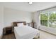 Light-filled bedroom with desk by window, hardwood floors, and modern furnishings at 7551 Bear Claw Run, Orlando, FL 32825