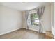 Bright bedroom with wood floors, large window, and stylish gray curtains at 7551 Bear Claw Run, Orlando, FL 32825
