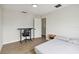 Bright bedroom with wood floors features an ensuite bathroom, creating a private and functional living space at 7551 Bear Claw Run, Orlando, FL 32825