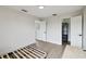 Bedroom featuring wood-look floors, closet with shelving, and entry to another room at 7551 Bear Claw Run, Orlando, FL 32825