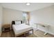 Bedroom boasts hardwood floors, with a desk, a nightstand, and lots of sunlight at 7551 Bear Claw Run, Orlando, FL 32825