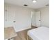 Light-filled bedroom featuring hard wood floors, desk, access to another room and closet at 7551 Bear Claw Run, Orlando, FL 32825