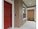 Close-up of the red front door and adjacent window, highlighting the home's entry and facade at 7551 Bear Claw Run, Orlando, FL 32825