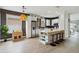 Modern kitchen boasts white cabinets, stainless appliances, and a large island with seating at 7551 Bear Claw Run, Orlando, FL 32825