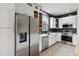 Updated kitchen features stainless steel appliances, white cabinets, and a modern backsplash at 7551 Bear Claw Run, Orlando, FL 32825