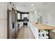Modern kitchen with stainless steel appliances, island, and white cabinets, bright and airy at 7551 Bear Claw Run, Orlando, FL 32825
