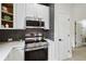 Well-appointed kitchen with stainless appliances, white cabinets, and eat-in space at 7551 Bear Claw Run, Orlando, FL 32825