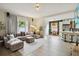 Open-concept living space with hardwood floors, comfortable seating, and great natural light at 7551 Bear Claw Run, Orlando, FL 32825