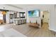 Spacious living room with an open floor plan leading to a modern kitchen and dining area at 7551 Bear Claw Run, Orlando, FL 32825
