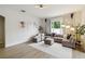 Spacious living room with hardwood floors, a neutral color palette, and modern decor at 7551 Bear Claw Run, Orlando, FL 32825