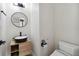 Stylish powder room with a vessel sink, modern lighting, and elegant design for guests' convenience at 7551 Bear Claw Run, Orlando, FL 32825