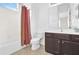 Bathroom featuring tile floors, modern vanity, and shower-tub combo at 7710 Linkside Loop, Reunion, FL 34747
