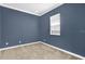 Comfortable bedroom offers natural light and neutral carpet at 7710 Linkside Loop, Reunion, FL 34747