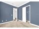 Bedroom featuring neutral carpet, fresh paint, with closet and doorway at 7710 Linkside Loop, Reunion, FL 34747