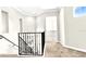 Second-floor landing area with iron railing, neutral-toned walls and carpeting at 7710 Linkside Loop, Reunion, FL 34747
