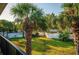 Landscaped backyard featuring vibrant green grass, and palm trees enclosed by a white picket fence at 7900 S Orange Blossom Trail # 2041, Orlando, FL 32809