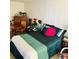 Cozy bedroom features a bed, dresser, and accent furniture at 7900 S Orange Blossom Trail # 2041, Orlando, FL 32809