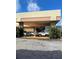 Front exterior of building with portico, showing parking and landscaping at 7900 S Orange Blossom Trail # 2041, Orlando, FL 32809