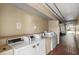 Clean, tiled laundry room with multiple washers and dryers at 7900 S Orange Blossom Trail # 2041, Orlando, FL 32809