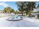 Well-maintained hot tub area with tiled borders surrounded by lounge chairs and lush trees at 7900 S Orange Blossom Trail # 2041, Orlando, FL 32809