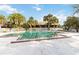Inviting swimming pool area surrounded by lounge chairs, palm trees, and a white picket fence at 7900 S Orange Blossom Trail # 2041, Orlando, FL 32809