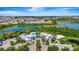 Aerial view of community featuring a resort-style pool, clubhouse, and well-manicured landscaping near a lake at 809 Benoi Dr, Davenport, FL 33896