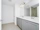 Bathroom featuring double sink vanity, large mirror, and walk-in shower at 809 Benoi Dr, Davenport, FL 33896