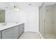 Bright bathroom featuring double sink vanity, large mirror, and walk-in shower at 809 Benoi Dr, Davenport, FL 33896