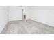 Spacious bedroom with door and large carpeted floor at 809 Benoi Dr, Davenport, FL 33896