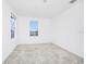 A bright bedroom with a window and light gray carpet at 809 Benoi Dr, Davenport, FL 33896