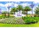 Landscaped entrance sign to Festival Resort Orlando with palm trees and flowering bushes at 809 Benoi Dr, Davenport, FL 33896