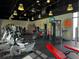 Spacious fitness center featuring modern exercise equipment, vibrant wall art, and ample natural light at 809 Benoi Dr, Davenport, FL 33896