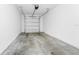 Spacious garage with concrete floor and white walls and door at 809 Benoi Dr, Davenport, FL 33896