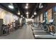 Bright fitness center with cardio and strength equipment, featuring brick walls and mirrored accents at 809 Benoi Dr, Davenport, FL 33896