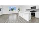 Bright open concept kitchen features stainless appliances, quartz countertops, and tile flooring at 809 Benoi Dr, Davenport, FL 33896