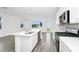 Open kitchen features a center island with a sink, stainless appliances, and bright cabinets at 809 Benoi Dr, Davenport, FL 33896