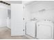Convenient laundry room featuring a washer and dryer and shelving at 809 Benoi Dr, Davenport, FL 33896