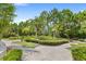 Scenic putting green area featuring decorative shrubbery, palm trees, and a beautiful walkway at 809 Benoi Dr, Davenport, FL 33896