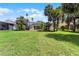 Large, manicured backyard with a swimming pool under a screened in patio, surrounded by mature trees at 821 Shallow Brook Ave, Winter Springs, FL 32708