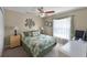 Comfortable bedroom featuring a ceiling fan, neutral walls, and green bedding, creating a relaxing and inviting space at 821 Shallow Brook Ave, Winter Springs, FL 32708