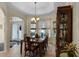 Charming dining space with a tray ceiling, natural light, and ample room for a large dining table at 821 Shallow Brook Ave, Winter Springs, FL 32708