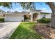 Charming one-story home with a well-manicured lawn, a two-car garage and an arched entryway at 821 Shallow Brook Ave, Winter Springs, FL 32708