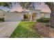 Charming single-story home featuring a well-manicured lawn and inviting front porch with elegant architectural details at 821 Shallow Brook Ave, Winter Springs, FL 32708