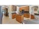 Well-lit kitchen featuring wooden cabinets, granite countertops, and a center island at 821 Shallow Brook Ave, Winter Springs, FL 32708