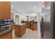 Open kitchen with stainless steel appliances, center island, and tile flooring at 821 Shallow Brook Ave, Winter Springs, FL 32708