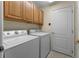 Laundry room with washer, dryer and built-in cabinets at 821 Shallow Brook Ave, Winter Springs, FL 32708