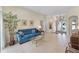 Bright and airy living room with neutral walls, tiled flooring, large windows and ample seating space at 821 Shallow Brook Ave, Winter Springs, FL 32708